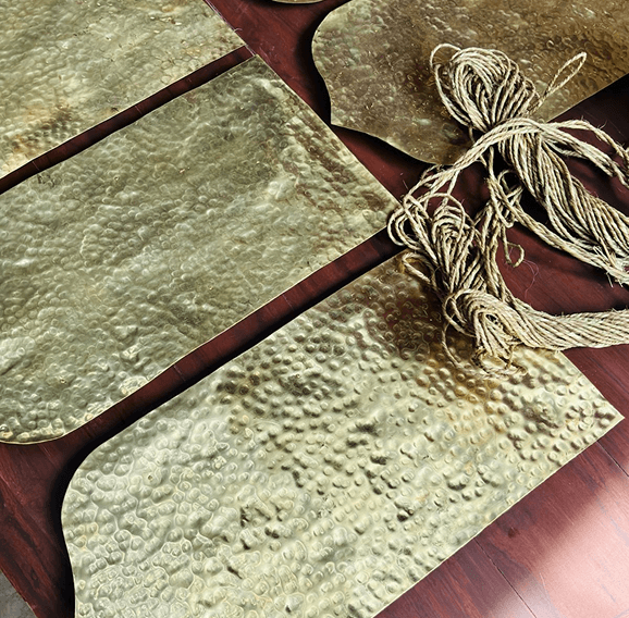 Hand-hammered brass templates with tied twine